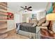 Spacious main bedroom with tile floors, artwork, ceiling fan, and an ensuite bathroom at 4101 Hollowtrail Dr, Tampa, FL 33624