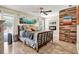 Comfortable main bedroom with a ceiling fan, wood accent wall, and a fireplace at 4101 Hollowtrail Dr, Tampa, FL 33624