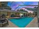 Beautiful backyard showcases a sparkling pool with a screened enclosure and outdoor seating area at 4101 Hollowtrail Dr, Tampa, FL 33624