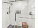 The renovated shower features sleek subway tile, glass door, and dark tile flooring at 4101 Hollowtrail Dr, Tampa, FL 33624