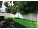 Backyard featuring a well maintained lawn, privacy fence, and patio seating at 4106 N Thatcher, Tampa, FL 33614