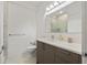 Bathroom with a gray vanity, white countertop, mirror, and glass-enclosed shower featuring white marble-style tiles at 4106 N Thatcher, Tampa, FL 33614