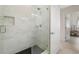 Shower featuring white marble-style tiles, a built-in niche, a rainfall shower head, and black hexagon floor tiles at 4106 N Thatcher, Tampa, FL 33614