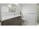 Bright bathroom featuring a gray vanity, white countertop, and a glass-enclosed shower with white marble-style tiles at 4106 N Thatcher, Tampa, FL 33614