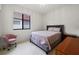 Cozy bedroom with gray bed, pink bedding, a pink chair, and a window providing natural light at 4106 N Thatcher, Tampa, FL 33614