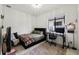 A modern bedroom has a black bed frame, a black desk, a grey rug, and large window at 4106 N Thatcher, Tampa, FL 33614
