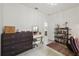 Bedroom with dark wood dresser, vanity with lighted mirror, and decorative bookshelf at 4106 N Thatcher, Tampa, FL 33614