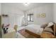 Bright bedroom with white walls, closet doors, and natural light from a large window at 4106 N Thatcher, Tampa, FL 33614
