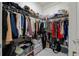 A fully stocked walk in closet with shelves, hanging racks, storage bins, and clothing at 4106 N Thatcher, Tampa, FL 33614