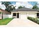 A charming home features a two-car garage, nice landscaping and freshly painted exterior at 4106 N Thatcher, Tampa, FL 33614