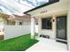 The exterior of this home has a covered front porch, a well-manicured lawn, and a modern paint scheme at 4106 N Thatcher, Tampa, FL 33614