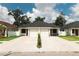 Charming duplex featuring a well-manicured lawn and matching attached two-car garages at 4106 N Thatcher, Tampa, FL 33614