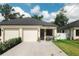 A cozy duplex with a two-car garage and small shrubbery at 4106 N Thatcher, Tampa, FL 33614
