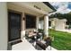 Inviting front porch seating area with a cozy chair and potted plants at 4106 N Thatcher, Tampa, FL 33614