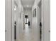 Long hallway with white doors and tile flooring at 4106 N Thatcher, Tampa, FL 33614