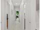 The long hallway features white doors and trim, leading to the different rooms of the house at 4106 N Thatcher, Tampa, FL 33614