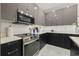 Kitchen featuring sleek stainless steel appliances and white countertop with black cabinets at 4106 N Thatcher, Tampa, FL 33614