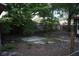 Large open backyard with a concrete foundation and mature trees at 4114 E Sewaha St, Tampa, FL 33617