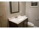 Bathroom features a tiled shower, toilet and vanity with sink and mirror at 4114 E Sewaha St, Tampa, FL 33617