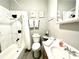 Well-lit bathroom features a shower-tub combo, sink, toilet, and decorative elements for a comfortable experience at 4114 E Sewaha St, Tampa, FL 33617