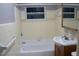 Bathroom features a tub and shower combination, toilet and vanity with sink and mirror at 4114 E Sewaha St, Tampa, FL 33617