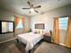Well-lit bedroom showcasing a ceiling fan, comfortable bed, and stylish decor for a serene retreat at 4114 E Sewaha St, Tampa, FL 33617