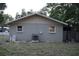 Rear exterior view of the house featuring a fenced yard at 4114 E Sewaha St, Tampa, FL 33617