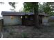 Rear exterior view of the house featuring an enclosed porch at 4114 E Sewaha St, Tampa, FL 33617