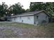 Exterior view of a single-story home featuring new windows and fresh exterior paint at 4114 E Sewaha St, Tampa, FL 33617