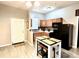 Bright kitchen featuring tile floors, stainless steel appliances and a modern white table with chairs at 4114 E Sewaha St, Tampa, FL 33617
