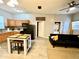 Spacious living room featuring tile floors and an open floor plan leading to the kitchen at 4114 E Sewaha St, Tampa, FL 33617
