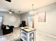 Spacious living room with tile floors, ceiling fan and a modern white table at 4114 E Sewaha St, Tampa, FL 33617