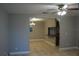 Open-concept living room features neutral paint and tile flooring, creating a seamless flow into the dining area at 4114 E Sewaha St, Tampa, FL 33617