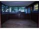 Covered back porch with a wooden floor and screened windows at 4114 E Sewaha St, Tampa, FL 33617