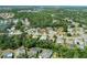 Aerial view of a residential neighborhood featuring mature trees, community lakes, and various housing styles at 4317 74Th E Ave, Sarasota, FL 34243