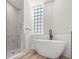 Bright bathroom featuring walk-in shower, soaking tub, and subway tile accents at 4317 74Th E Ave, Sarasota, FL 34243