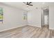 Bright bedroom with wood-look flooring and multiple windows at 4317 74Th E Ave, Sarasota, FL 34243