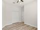 Neat bedroom with wood-look flooring, ceiling fan, closet and white trim throughout at 4317 74Th E Ave, Sarasota, FL 34243