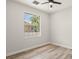 Cozy bedroom with neutral walls, modern ceiling fan, and a large window overlooking the exterior at 4317 74Th E Ave, Sarasota, FL 34243