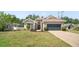 Inviting home with a well-manicured lawn, lush landscaping, and a spacious two-car garage at 4317 74Th E Ave, Sarasota, FL 34243