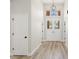 Bright foyer with wood floors, a modern chandelier, and a double-door entrance at 4317 74Th E Ave, Sarasota, FL 34243