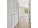 Hallway featuring closet with louvered doors and view to outside at 4317 74Th E Ave, Sarasota, FL 34243