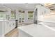 Modern kitchen featuring stainless steel appliances, white cabinets, and a stone countertop island at 4317 74Th E Ave, Sarasota, FL 34243