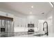 Modern kitchen featuring white cabinetry, stainless steel appliances, and a breakfast bar at 4317 74Th E Ave, Sarasota, FL 34243