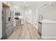 Bright kitchen with stainless steel appliances, white cabinets, and wood-style flooring at 4317 74Th E Ave, Sarasota, FL 34243