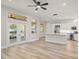 Open-concept living space with hardwood floors, a kitchen island, and plenty of natural light at 4317 74Th E Ave, Sarasota, FL 34243