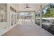 Inviting screened-in patio with a ceiling fan and views of the backyard and landscaping at 4317 74Th E Ave, Sarasota, FL 34243
