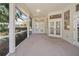 Spacious screened-in patio featuring multiple access doors and views of the backyard at 4317 74Th E Ave, Sarasota, FL 34243