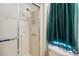The bathroom features a shower with a shower head and white fixtures against patterned walls at 4801 Blanco Dr, Zephyrhills, FL 33541