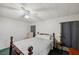 A cozy bedroom with wood bed, a ceiling fan, and a warm, inviting atmosphere for restful nights at 4801 Blanco Dr, Zephyrhills, FL 33541